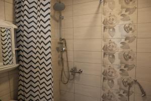 a bathroom with a shower with a shower curtain at Lotus Villas in Travnik +200 photos