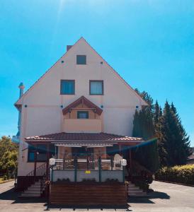 a large white building with aventh floor at Heiligenröder Pension in Niestetal