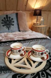 two cups of coffee on a tray on a bed at VILLA JAGODOVO Biały Dunajec in Biały Dunajec