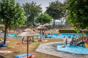 a group of people in a pool at a park at EuroParcs Gulperberg in Gulpen +57 photos