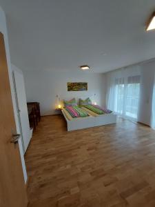 a white room with two beds and a wooden floor at good bed Deitingen in Deitingen