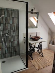 a bathroom with a shower and a vanity with a mirror at MM Apartman in Badacsonyörs