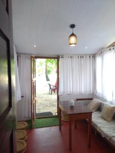 a living room with a couch and a table at SAMBODHI YOGA RETREAT in Alleppey +37 photos