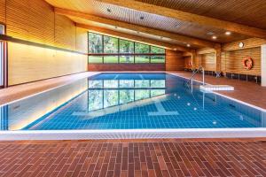 a swimming pool in a house with a ceiling at Ferienwohnung Fetscher 1 in Reichenau