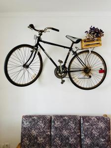 a bike hanging on a wall next to a couch at Fisherman´s Cave in Faro