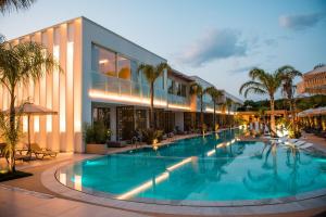 a large swimming pool in front of a building at Elite Bay Hotel Lalez Durres in Lalëz