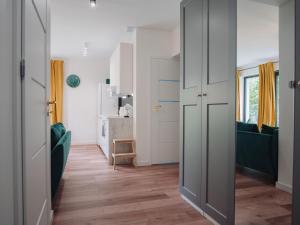 a room with a hallway with green furniture and a door at Apartament Nad Strumykiem z ogródkiem - Dream Apart in Ustroń