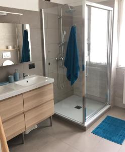 a bathroom with a shower with a sink and a shower stall at Da Tosca in Gravellona Toce