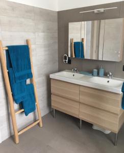 a bathroom with a sink and a blue towel at Da Tosca in Gravellona Toce +11 photos