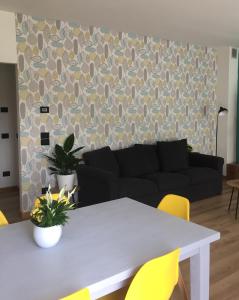 a living room with a white table and yellow chairs at Da Tosca in Gravellona Toce