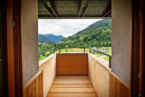 a balcony with a view of a mountain at La Marmote Albergo Diffuso di Paluzza Aip in Paluzza