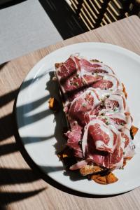 a piece of meat on a plate on a table at Helios Mallorca Hotel & Apartments in Can Pastilla