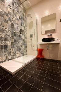 a bathroom with a shower and a glass shower stall at Quaint Boutique Hotel Sannat in Sannat