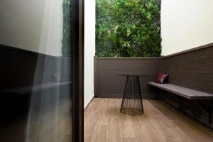 a room with a bench and a large window at Quaint Boutique Hotel Sannat in Sannat