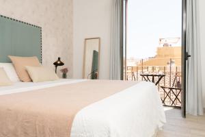 A bed or beds in a room at iloftmalaga Carretería - Puerta de Antequera