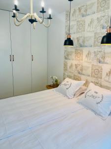 a bedroom with a large white bed with two pillows at Apartament Batorego 713 in Gdynia