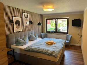 a bedroom with a bed and a window at Pension & Café Abendröte in Oybin