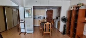 a kitchen with a table and chairs in a room at Hotel Villa Vanessa in Siltakylä
