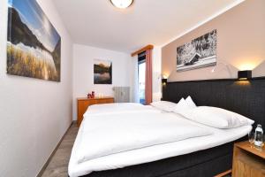 Posteľ alebo postele v izbe v ubytovaní Familienhotel Kleinwalsertal