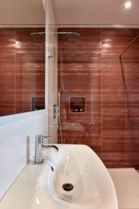 a bathroom with a sink and a shower at Quaint Boutique Hotel Sannat in Sannat