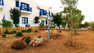 a house with a garden in front of it at Aegean Star Hotel in Karavostasi