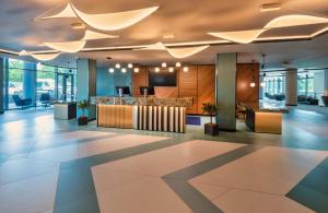 an office lobby with a reception desk and ceiling at Hunguest Hotel Bál Resort in Balatonalmádi