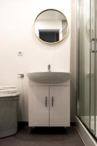 a bathroom with a sink and a mirror on the wall at YouthMents - Student Hotel in Rīga