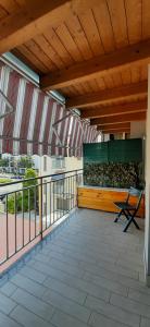 a balcony with a bench and a fence at La Casa Di Emma in Rozzano