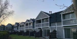 a row of apartment buildings with a fence at Lagoon City Pier One Resort in Brechin