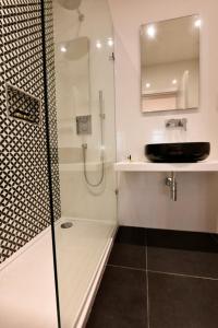 a bathroom with a shower and a sink at Quaint Boutique Hotel Sannat in Sannat