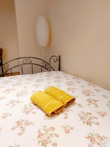 a yellow towel sitting on top of a bed at Apartament Retro Promenada in Ełk