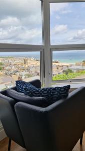 a couch in a room with a large window at Harbour View Guest House in St Ives