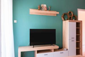 a flat screen tv sitting on top of a wall at Home Away From Home in Perea