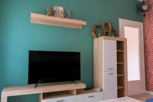 a living room with a flat screen tv on a wall at Home Away From Home in Perea +10 photos