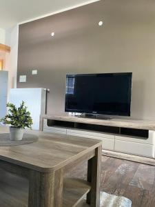 a living room with a large flat screen tv at Apartma Stres in Bovec