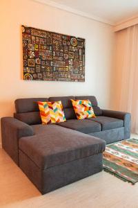a living room with a brown couch with pillows at Home Away From Home in Perea
