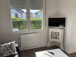 Televízia a/alebo spoločenská miestnosť v ubytovaní Maison de vacances pour 8 personnes STELLA PLAGE - Villa POPPEE + 5 fotografií