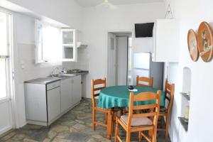 a kitchen with a table and chairs in a room at Fabrika's Breeze in Vári