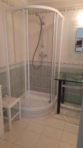 a bathroom with a shower with a table and a desk at Semi-Detached Villa in Vilamoura