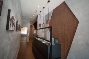 a display case in a hallway with a brick wall at Quaint Boutique Hotel Sannat in Sannat