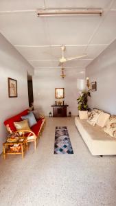 a living room with two beds and a couch at Angel Spa Garden's Homestay in Ipoh