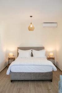 a bedroom with a large bed with two side tables at MNP Apartments in Engares