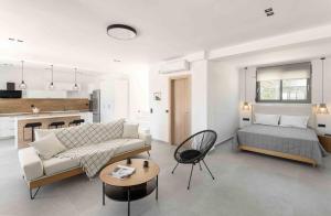 a living room with a couch and a bed at Koni Villas Agia Paraskevi by Halkidiki Villas in Agia Paraskevi