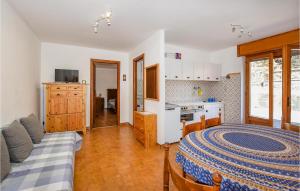 a living room with a bed and a kitchen at Casa Maria Grazia in Sauze dʼOulx