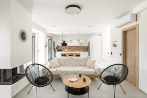 a living room with a couch and two chairs and a table at Koni Villas Agia Paraskevi by Halkidiki Villas in Agia Paraskevi +35 photos
