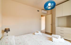 A bed or beds in a room at Amazing Home In Puegnago Sul Garda