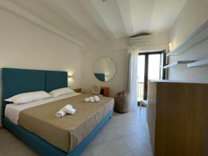 a bedroom with a bed with towels on it at MARE NOSTRUM in Fasano