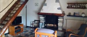 a living room with a fireplace and a television at Gîte de la Séoube in Campan