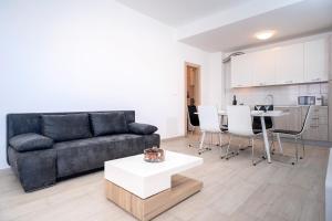 a living room with a couch and a table at Apartments Mistral in Bol