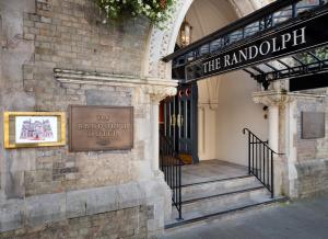 a stairway leading to a building with a clock on it at The Randolph Hotel, by Graduate Hotels in Oxford